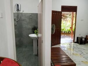 a bathroom with a sink and a toilet and a shower at Sunrise Villa Pidurangala in Sigiriya +75 photos