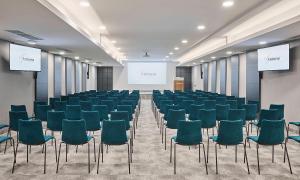 a conference room with chairs and a projection screen at Aminess Vival Maestral Hotel in Novigrad Istria +104 photos