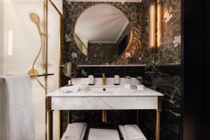 a bathroom with a sink and a mirror at Wonder - The Luxury Boutique Hotel in Budapest