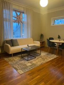a living room with a couch and a table at Brekkehagen in Skien