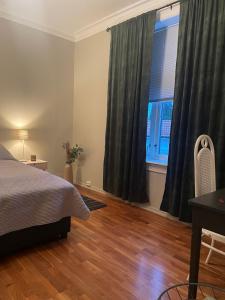 a bedroom with a bed and a large window at Brekkehagen in Skien