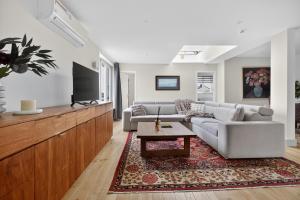 a living room with a couch and a tv at Maison Lombard by Reside in Brussels