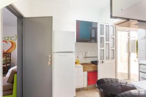 a kitchen with white appliances and a refrigerator at Blife Sonya private rooms at Faro beach in Faro