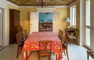 a dining room with a table with a red table cloth at Pet Friendly Home In Haarby With Sauna in Brydegård