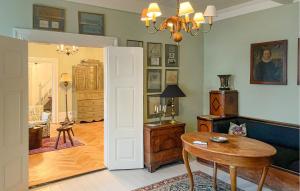 a living room with a table and a dining room at Pet Friendly Home In Haarby With Sauna in Brydegård