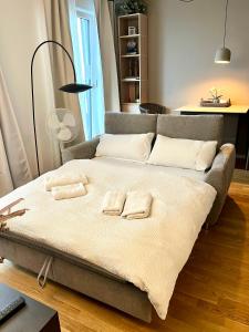a bed with two towels on it in a room at Rooftop Apartment,Business trip,Fast Internet in Schönefeld