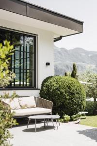 a bench in front of a house at Hotel Garni Andrianerhof in Andrian
