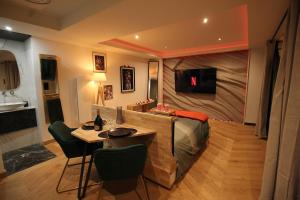 a bedroom with a large bed and a table and chairs at L'adorable in Valence