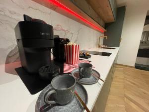 a kitchen with two cups on a counter at L'adorable in Valence