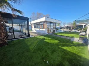 a house with a green lawn in front of it at ZEN Villa in Rrushkull