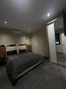 a bedroom with a large bed and a large window at ZEN Villa in Rrushkull +44 photos