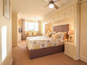 a bedroom with a large bed and a window at Llwyn Derw in Talybont