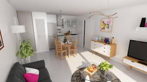 a living room with a couch and a table at Les Bastides in Mimizan