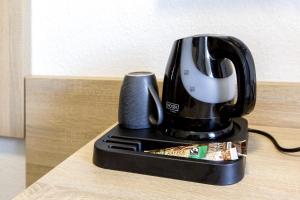 a coffee maker sitting on top of a table at Hotel Pension Odin in Berlin