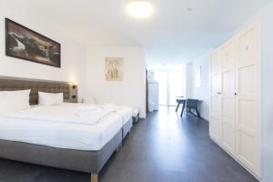 a hotel room with two beds and a table at Hotel Pension Odin in Berlin