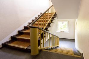 a staircase with wooden steps in a house at Hotel Pension Odin in Berlin +23 photos