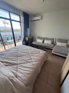 a bedroom with a large bed and a couch at KataKeet in Kata Beach
