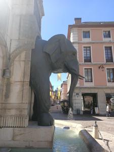 a statue of an elephant drinking water from a fountain at Centre Chambéry - Parking gratuit - tout inclus in Chambéry