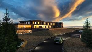 a building with a car parked in front of it at 360 Hotel Boutique and Spa in Selfoss