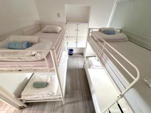 a group of four bunk beds in a room at Blife Sonya private rooms at Faro beach in Faro