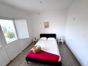 a bedroom with a large bed with a red blanket at Blife Sonya private rooms at Faro beach in Faro
