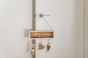 a sign that says come to the beach with shoes at Allure at Hyams Beach - seconds to white sands in Hyams Beach