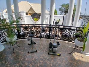 a balcony with chairs and exercise equipment on it at Miky Hillside Lodge in Sunyani