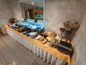 a buffet line with food on it in a restaurant at Felicity Garni Hotel in Bratislava