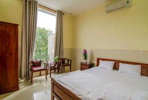 Säng eller sängar i ett rum på Kim Hồng Nhật Guest House