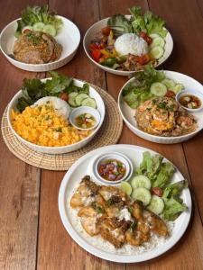 a group of plates of food on a table at The Pool House Koh Lanta in Ko Lanta