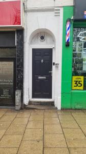 a black door on the side of a building at City Stays Norwich in Norwich
