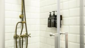 a shower with two oxygen bottles on the wall at Hotel Catalina Suites in Valencia +60 photos