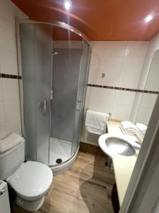 a bathroom with a shower and a toilet and a sink at Hôtel Icare in Toulouse