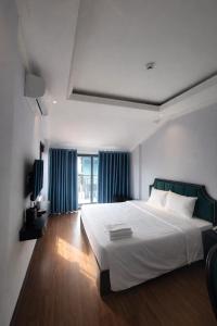 a bedroom with a large bed and a television at Maya Central Hotel & Spa in Hanoi