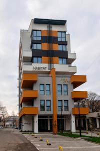 a building with an orange and white at Habitat Suites - Modern Apartments with Terraces and Free Parking in Craiova