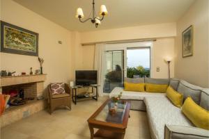 a living room with a couch and a fireplace at Villa Verona Pool in Lachania +24 photos