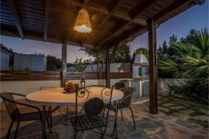 a patio with a table and chairs on a patio at Villa Verona Pool in Lachania