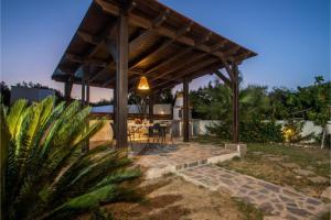 a pavilion with a table and chairs in a backyard at Villa Verona Pool in Lachania