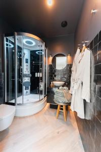 a bathroom with a large shower and a sink at The Gentle Arch Schiphol Amsterdam in Aalsmeer +36 photos