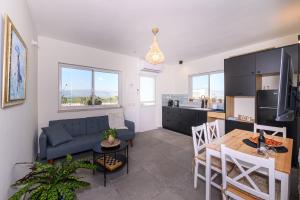 a living room with a couch and a table at שלווה בנוף העמק in Gonen