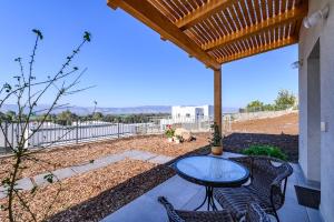 a patio with a table and chairs and a fence at שלווה בנוף העמק in Gonen