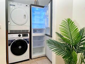 a refrigerator with its door open next to a dishwasher at 'GoldPath' OldTown - Apartments Passau in Passau