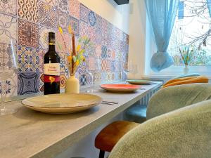 a bottle of wine sitting on a counter with a table at 'GoldPath' OldTown - Apartments Passau in Passau