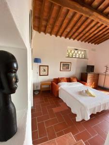 een slaapkamer met een bed en een standbeeld van een hoofd bij CasaLeTolfe Residence in Siena +118 foto's