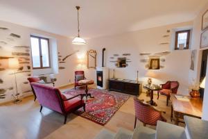 a living room filled with furniture and a fireplace at Castellu d'Orezza in Carcheto