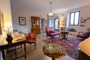 a living room with chairs and a table with a chessboard at Castellu d'Orezza in Carcheto