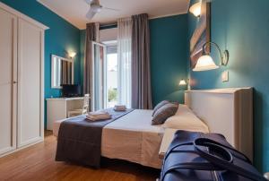 Postel nebo postele na pokoji v ubytování Hotel Gabicce Mare