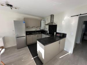 a kitchen with a refrigerator and a counter top at T3 proche aéroport in Saint-Jacques-de-la-Lande