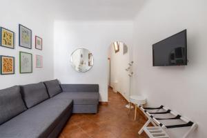 a living room with a couch and a flat screen tv at La Casetta di Via Sannio in Rome