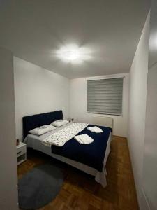 a bedroom with a bed with two towels on it at Apartman Nova Pale in Pale